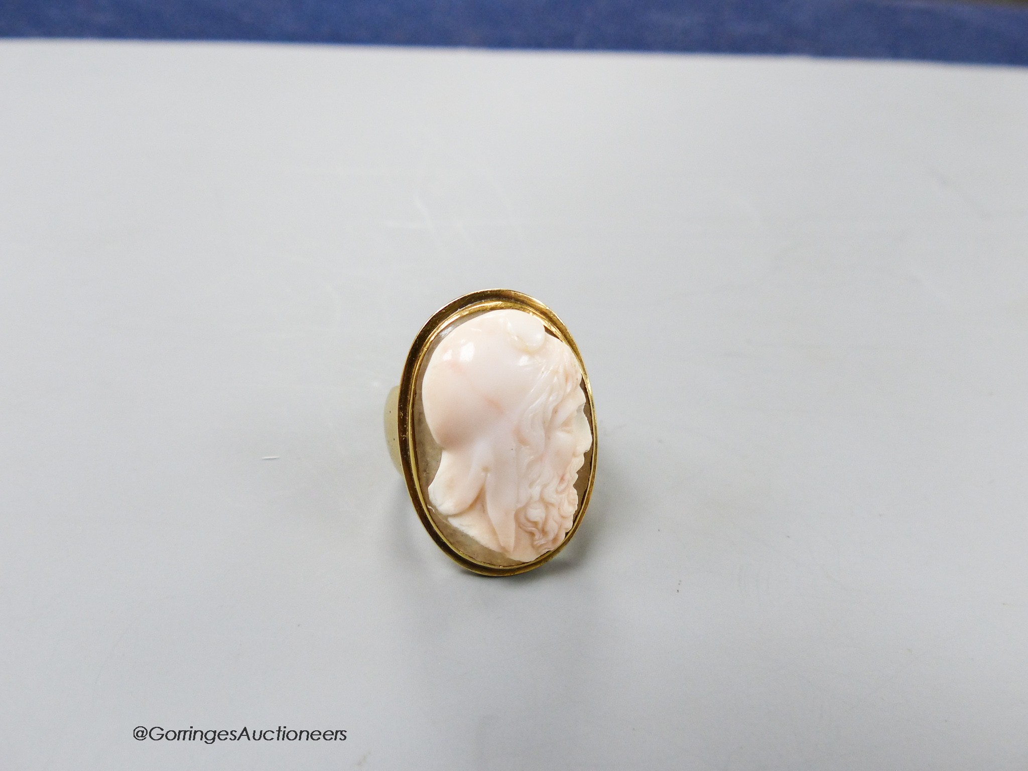 An antique yellow metal and oval cameo quartz? ring, carved with head of a gentlemen to sinister, size K, gross 13.2 grams.